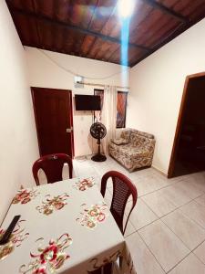 a dining room with a table and chairs and a couch at Estancia 2 in Tena