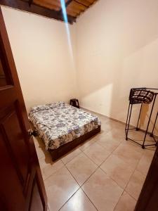 a bedroom with a bed and a chair in it at Estancia 2 in Tena