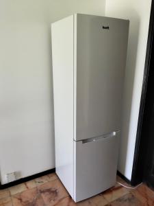 a white refrigerator in the corner of a room at Conceição Guesthouse in Tavira