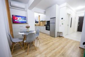 a kitchen and dining room with a table and chairs at Central Rent Apartments in Suceava