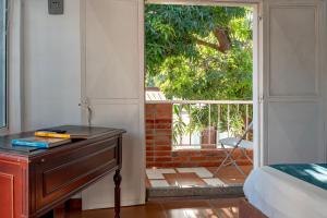 a bedroom with a bed and a door to a patio at Casa Blanca in Santa Marta