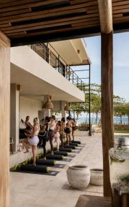 a group of people doing yoga on the stairs of a building at Selvamar Hermosa in Playa Hermosa