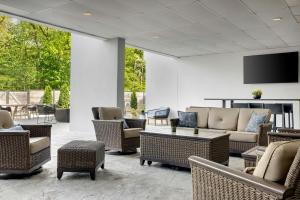 a lobby with couches and chairs and a tv at Marriott Park Ridge in Park Ridge