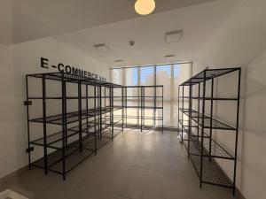 a room with three tiers of shelving at Studio cómodo y luminoso, a pasos del centro! - Bilingual Support Eng, Esp in Concepción