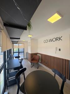 an office with tables and chairs and a sign that says go work at Studio cómodo y luminoso, a pasos del centro! - Bilingual Support Eng, Esp in Concepción
