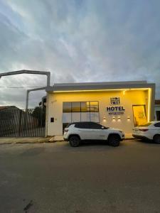 a white car parked in front of a hotel at Hotel maria araujo in Arapiraca