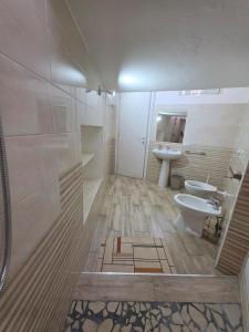 a bathroom with a toilet and a sink at Puteoli Stop vacation home in Pozzuoli +17 photos