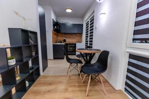 a small kitchen with a table and two chairs at IlieskiApartment in Prilep +2 photos