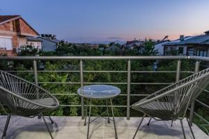 two chairs and a table on a balcony at IlieskiApartment in Prilep