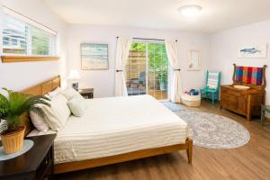 a bedroom with a bed and a desk and a window at Beach Bungalow in Rockaway Beach