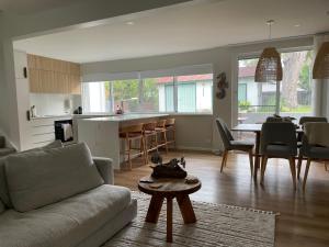 a living room with a couch and a table at Coastal Holiday House in Hawks Nest