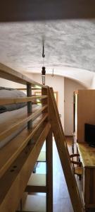 a view of a room with a bed and a table at Al Volto in Roncegno