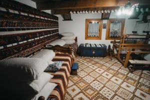 a room with a row of couches in a room at La Romaneasa in Săpânța +23 photos