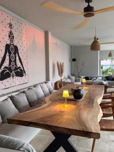a living room with a wooden table and a couch at Selvamar Hermosa in Playa Hermosa