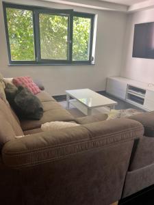 a living room with a couch and a table at Villa Belmonte in Weilheim an der Teck