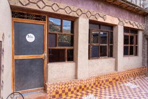 a building with a door and windows on it at Atlas Sud panorama in Imlil