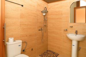 a bathroom with a shower and a toilet and a sink at Atlas Sud panorama in Imlil