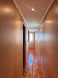 a hallway with a tile floor in a building at NurHome in Mejillones +1 photo