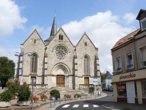a church with a clock on the front of it at Azur, Cosy Blue studio, ultra centre de Desvres in Desvres