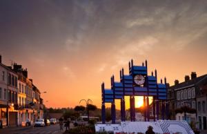 a clock tower in the middle of a street at Azur, Cosy Blue studio, ultra centre de Desvres in Desvres +1 photo