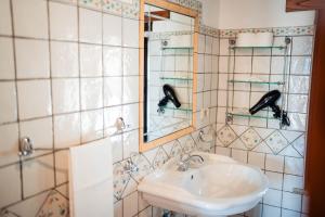 a bathroom with a sink and a mirror at Tenuta la Selva Casa I Lavatoi in Casal Velino