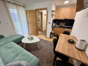 a living room with a couch and a table at SkyLux Vlašić in Šišava