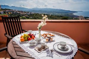 a table with a plate of food on top of a balcony at Tenuta la Selva Casa I Lavatoi in Casal Velino