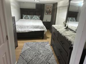 a bedroom with two beds and a mirror and a rug at Private basement apartment with separate entrance in Yonkers +2 photos