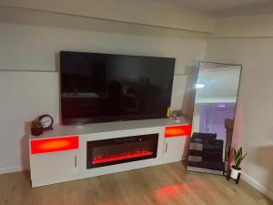 a living room with a tv and a fire place at Private basement apartment with separate entrance in Yonkers