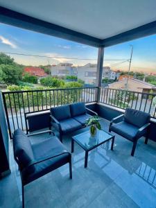 a balcony with two couches and a coffee table at Villa Ivana in Peroj