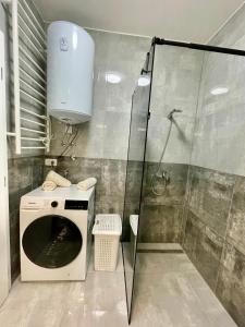 a washing machine in a bathroom with a shower at Villa Ivana in Peroj +18 photos