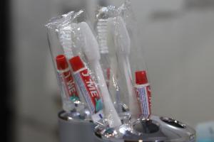 a container filled with toothbrushes and toothpaste at Lalveri INN in Mestia