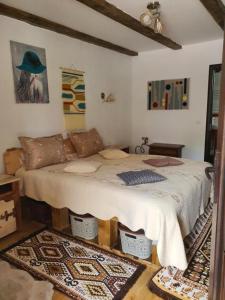 a bedroom with a large bed in a room at La Romaneasa in Săpânța
