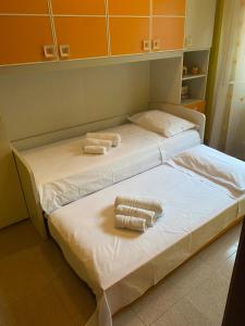 two beds in a room with towels on them at Casetta in Centro in San Salvo +4 photos