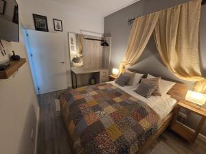 a bedroom with a bed with a quilt on it at Nieznany Bór 8 in Hajnówka