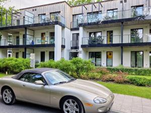 a silver car parked in front of a building at Nieznany Bór 8 in Hajnówka