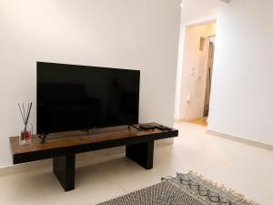 a flat screen tv sitting on a table in a living room at Ductus Aquae House in Évora