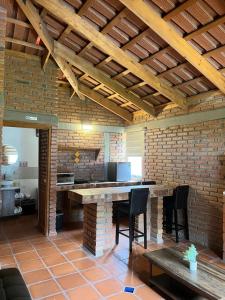 a room with a table and chairs and a brick wall at Cabañas Splash Valladolid in Jesús María +5 photos