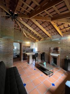 a living room with a fireplace and a table at Cabañas Splash Valladolid in Jesús María