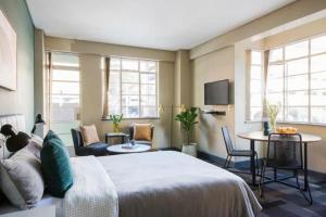 a bedroom with a bed and a table and chairs at Stylish 1BR in Durban