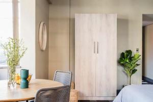 a dining room with a table and a cabinet at Stylish 1BR in Durban