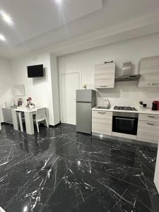 a kitchen with a stove and a table in it at Casa Birmano in Taranto +18 photos