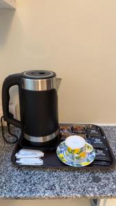 a coffee pot sitting on a tray on a counter at Shanayah house in Zanzibar City