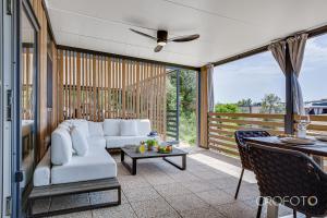 a living room with a white couch and a table at Mobile Home Altura Luxury Sea View Retreat in Drage