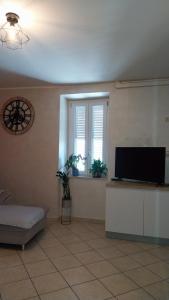 a living room with a flat screen tv and a window at Il Rigoletto Casa Vacanze in Lamezia Terme