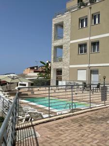 a building with a swimming pool in front of a building at Stelle Marine in Tropea