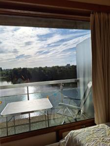 a bedroom with a window with a view of the water at Lagunabeach Knokke-Heist in Knokke-Heist +6 photos