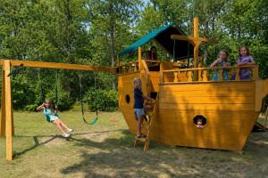 a group of children playing on a playground at Kennebunk Gallery Motel and Cottages in Kennebunk