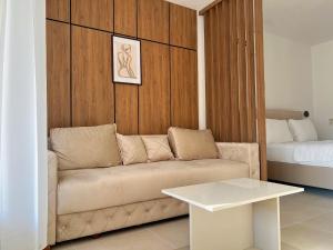a living room with a couch and a bed at Apartments Fat e Jet - Pool & Breakfast in Ulcinj