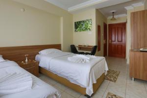 A bed or beds in a room at Gizem Pansiyon
